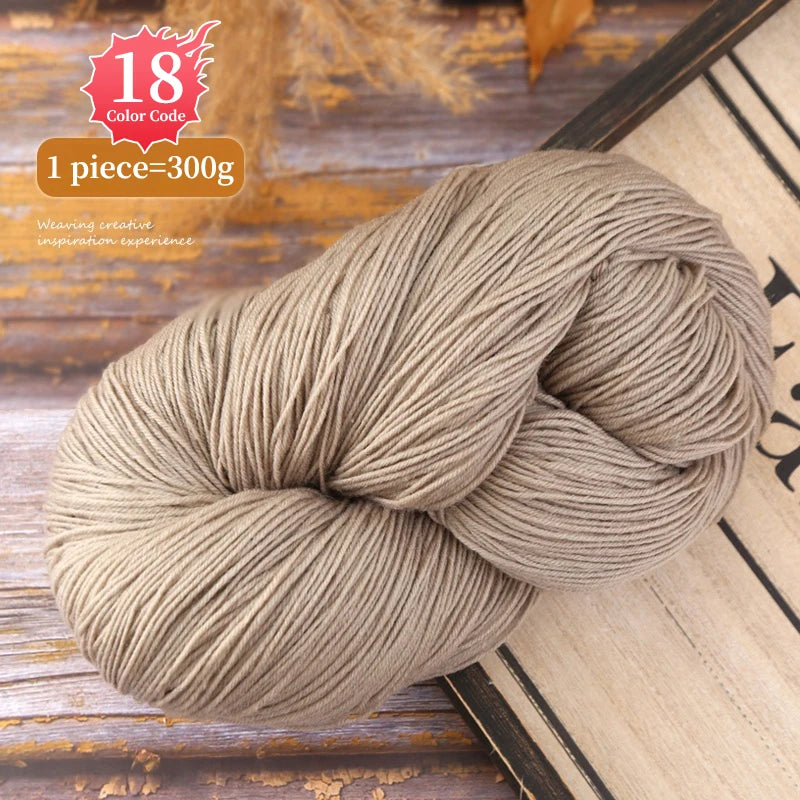 A ball of beige premium alpaca blend yarn used for knitting or weaving, shown on a wooden surface.