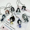 A set of black and white enamel pendants featuring characters from Mo Dao Zu Shi used as phone straps and keychains.