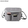 A gray Insular stroller organizer bag with a built-in bottle holder and shoulder straps.
