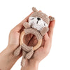 A hand holds a knitted brown bear rattle and teether ring made of wood