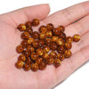 A handful of glossy, reddish-brown tiger eye resin beads for jewelry making.