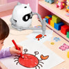 A child is drawing a dinosaur on paper using an interactive robot toy for toddlers.