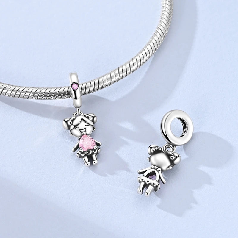 A silver heart charm bead with a pink zircon is attached to a sterling silver chain.