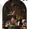 A glass jar filled with dried flowers and small silver-winged butterflies, showcasing the beauty of insects and flora.