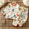 A white long sleeve cotton pajama set for children featuring colorful bears and stars on a grid background.