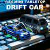 Voiture de drift miniature 1:64 bleues et blanches, en livrée de course, affichée sur un clavier.
