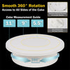 A white cake turntable with a 360 degree rotation feature and accompanying tools for decorating cakes.