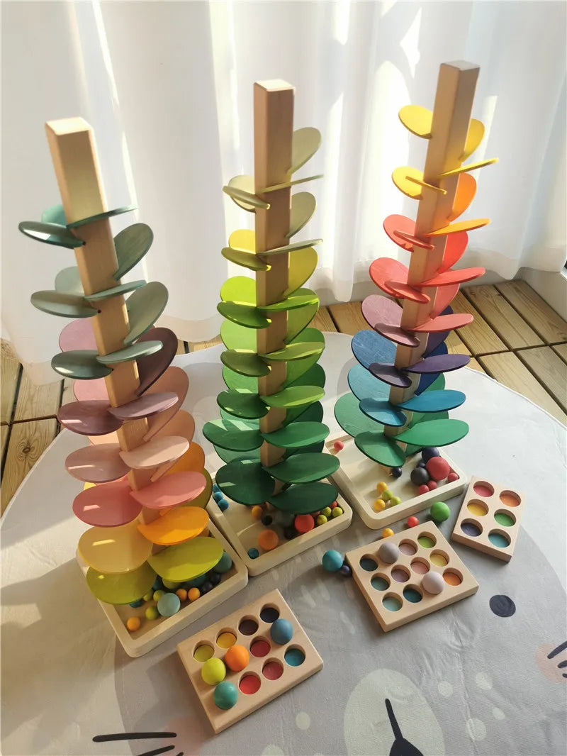 A wooden sensory music tree with a marble run featuring colorful, layered discs.