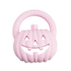 A pink silicone pumpkin baby teether with a textured handle and carved face for soothing relief.