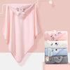 A pink hooded animal bath towel hanging on a white rack, with stacked towels below.