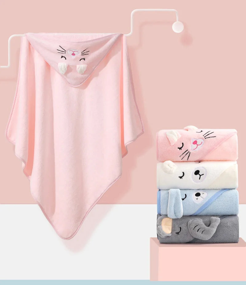 A pink hooded animal bath towel hanging on a white rack, with stacked towels below.
