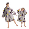 A young girl models a gray and purple cozy kids' flannel hoodie sweater for winter.
