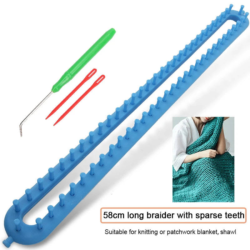 A blue brader with sparse teeth and a green hook shown next to a knitted blanket.