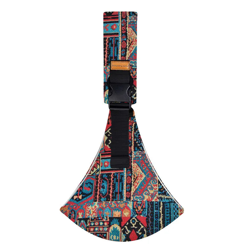 Adjustable baby sling carrier featuring a colorful patterned fabric and black strap.