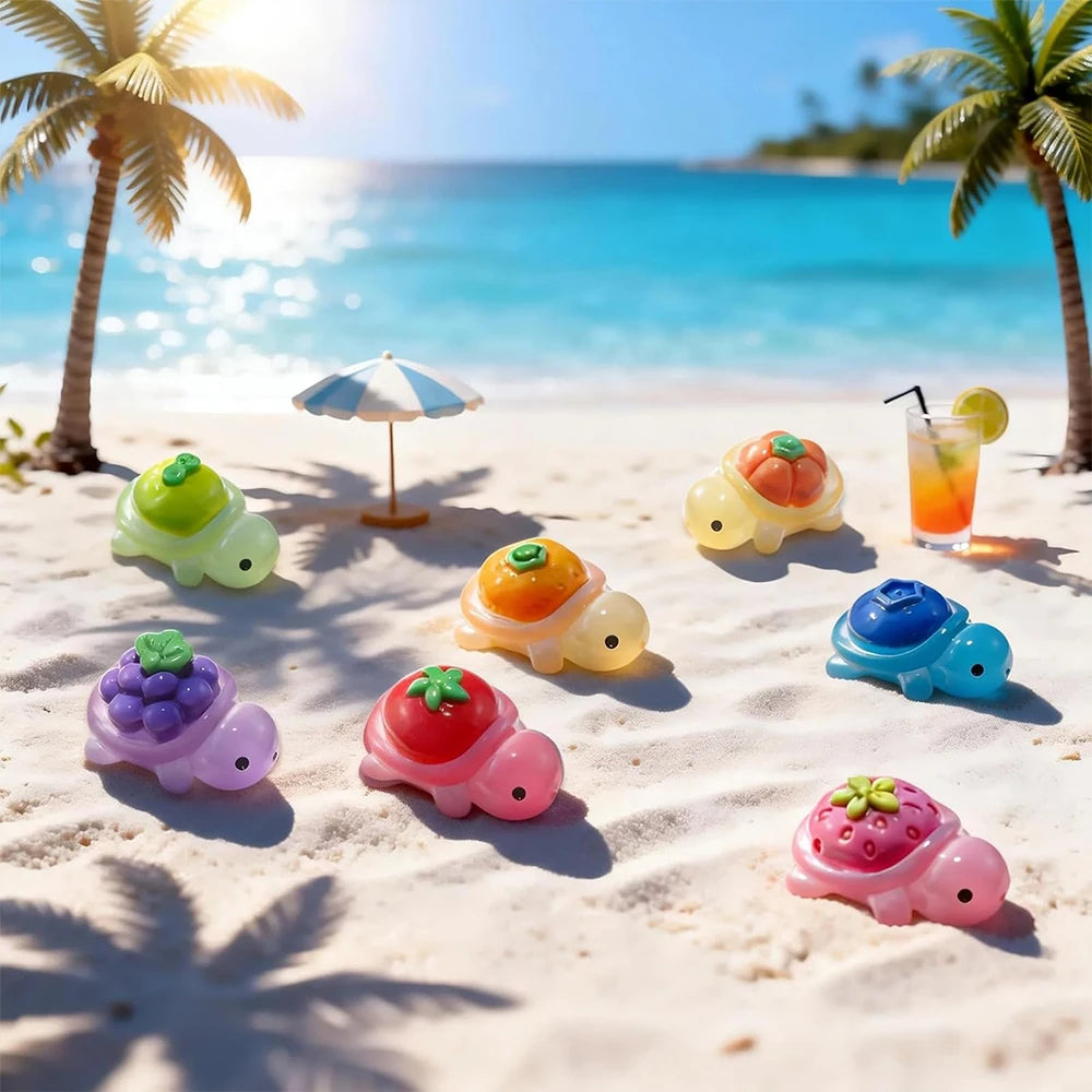 A set of mini glow-in-the-dark turtle resin figurines in various colors scattered on a sunny beach.