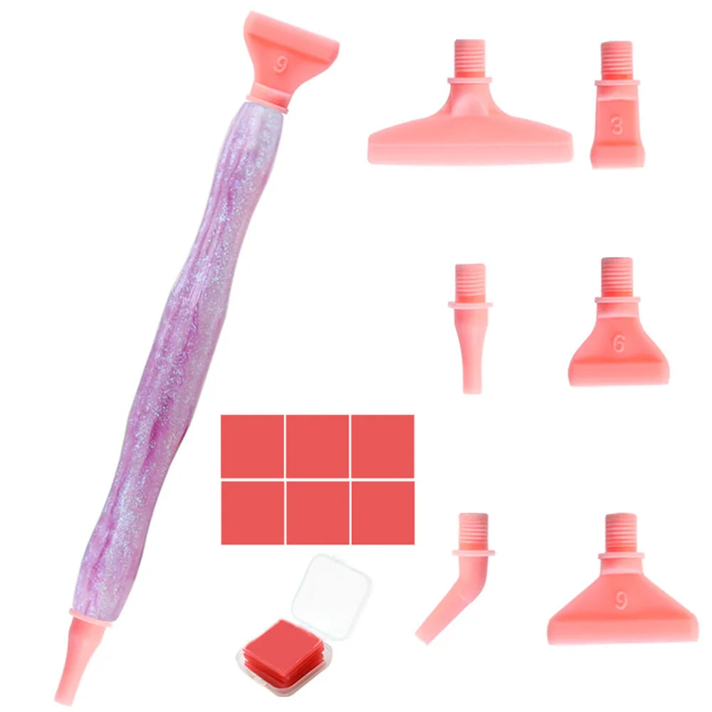 A set of pink resin diamond painting pens with interchangeable metal tips and multi-placers.