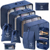 A set of navy blue travel packing cubes and storage bags with light beige lining.