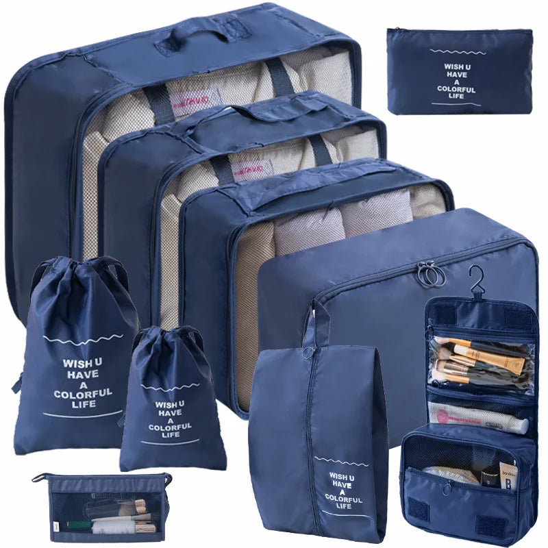 A set of navy blue travel packing cubes and storage bags with light beige lining.