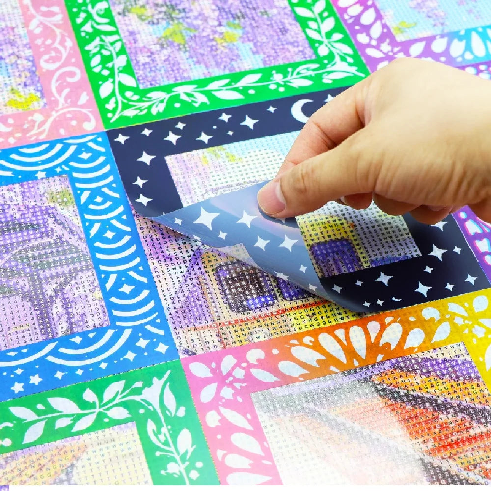 A hand is applying reusable non-stick release paper to a diamond painting surface.