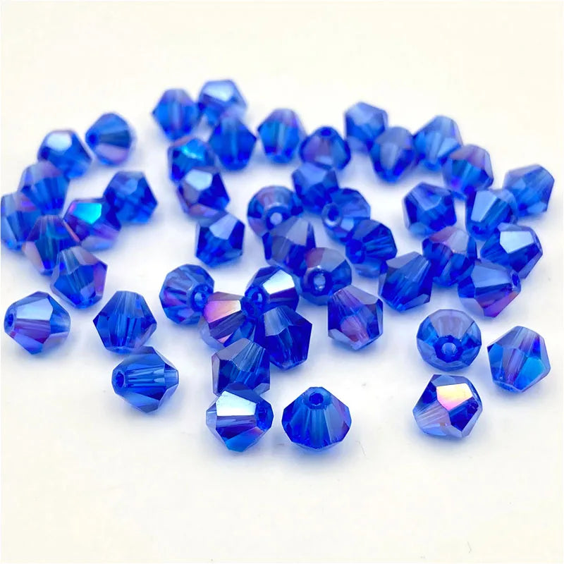 A collection of faceted blue to purple bicone crystal glass beads for jewelry making