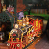 A detailed wooden miniature train locomotive and track set displayed in a diorama setting.
