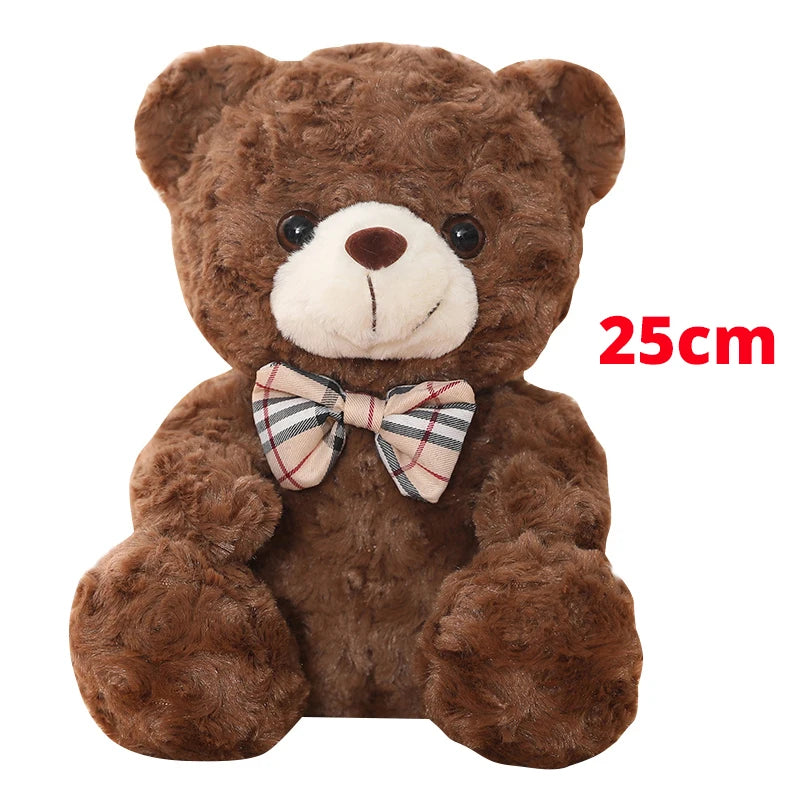 A brown teddy bear plush toy with a checkered bow, measuring 25cm.
