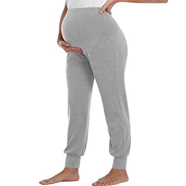 A person is wearing light gray high-waist stretch maternity joggers.