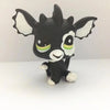 A black and white Littlest Pet Shop style standing dog figure with large ears and green accents.