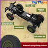 A black 1/12 scale off-road RC rock crawler truck featuring a reversing wave box, steering gear, and simulated leaf spring st