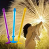 A set of four colorful water spray toys, including purple, blue, and yellow, are being used to create a bright light effect a