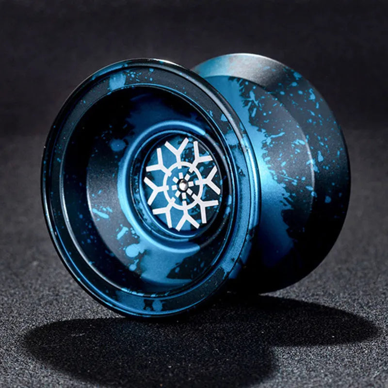 A close-up view of a blue aluminum alloy yo-yo with a textured surface and a central bearing mechanism.