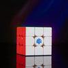 A red and white GAN 16 Maglev Max UV 3x3 magnetic speed cube resting on a reflective surface.