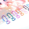 A collection of heart-shaped canvas clips in various colors and sizes for diamond painting and cross stitch.