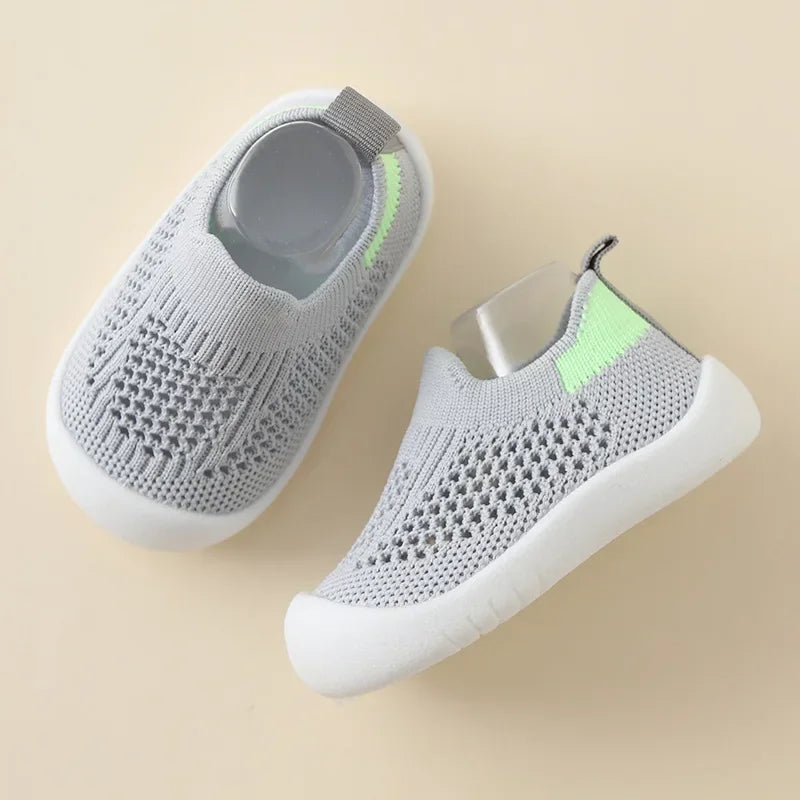 A pair of light gray breathable mesh slip-on sneakers for toddlers, shown from above.