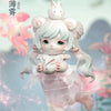A white collectible figurine of a girl with pink hair and rabbit ears, holding a small white egg.