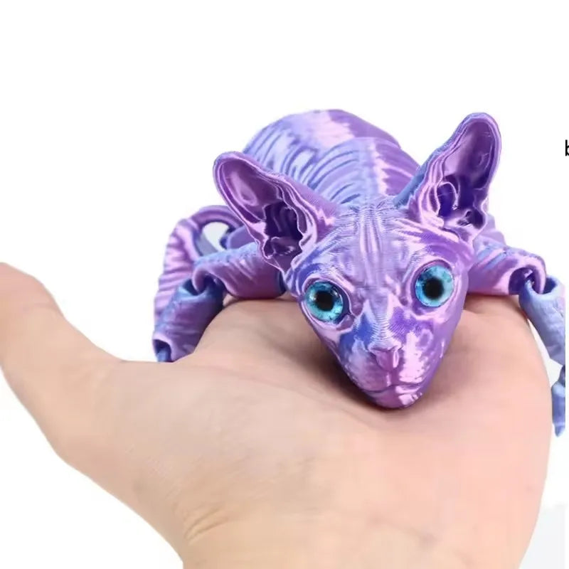 A purple articulated 3D printed figurine of a Sphynx cat with large blue eyes resting on a hand.