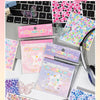 A collection of pink and purple cut film stickers in a book featuring butterfly and starry designs for scrapbooking