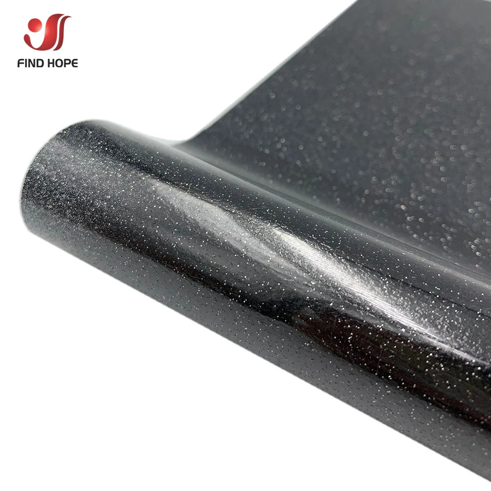 Close-up view of a black heat transfer vinyl roll with a glitter and holographic finish.
