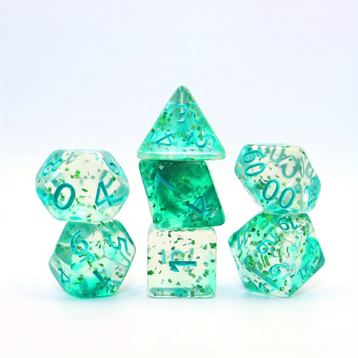 A set of green crystal style polyhedral dice, including a tetrahedron and dodecahedron, displayed on a white background.