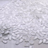 A pile of clear, teardrop-shaped water drop Czech glass beads for jewelry making.