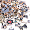 Assortment of gold-tone enamel charms for jewelry making featuring various shapes and designs