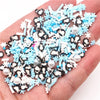 A handful of polymer clay slices in white, black, and light blue colors for DIY crafts