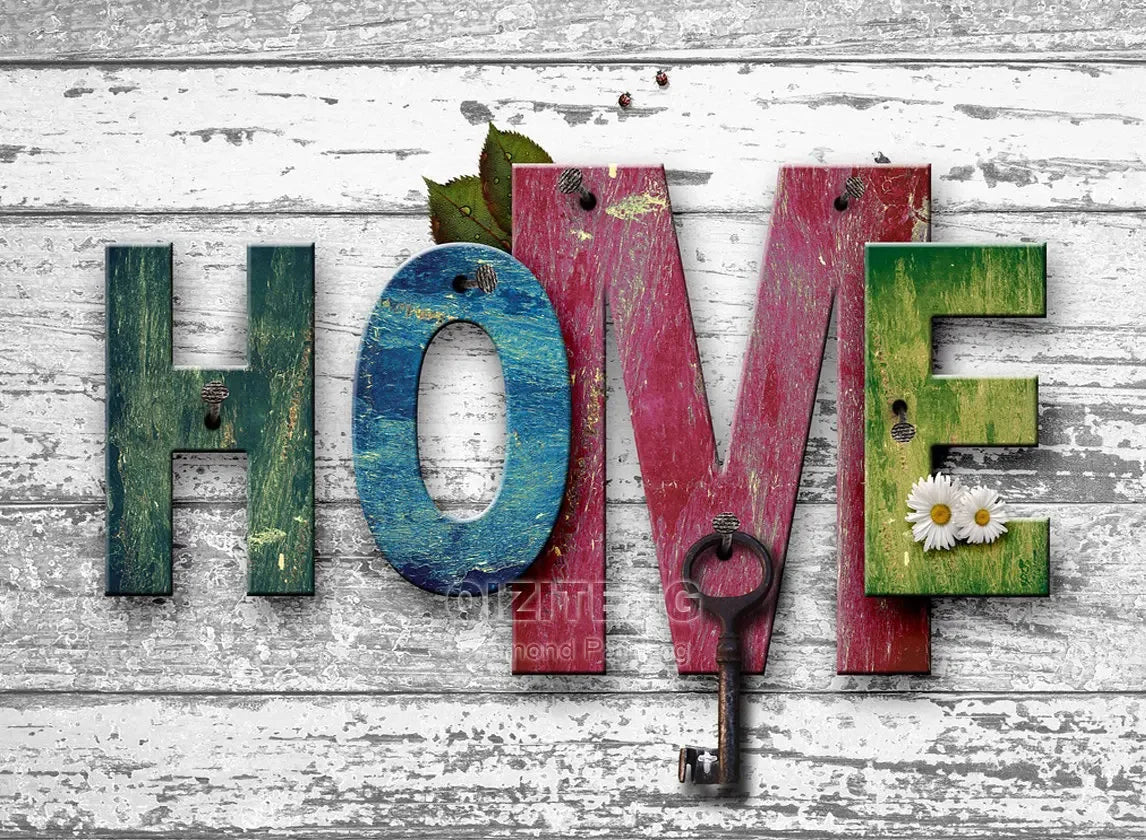 Wooden letters spelling LOVE HOME with a key on a distressed white wooden background