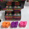 A collection of colorful squeeze stress relief toys and fidget balls in various shades of pink, orange, purple, and red.