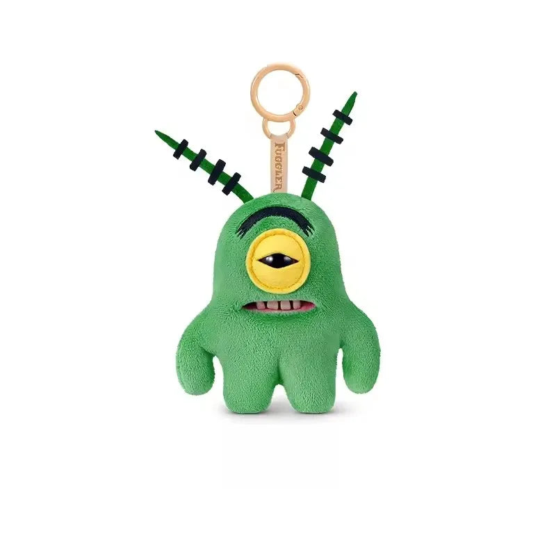 A green monster plush keychain with black spikes and a yellow eye, featuring the Fuggler x SpongeBob SquarePants design.