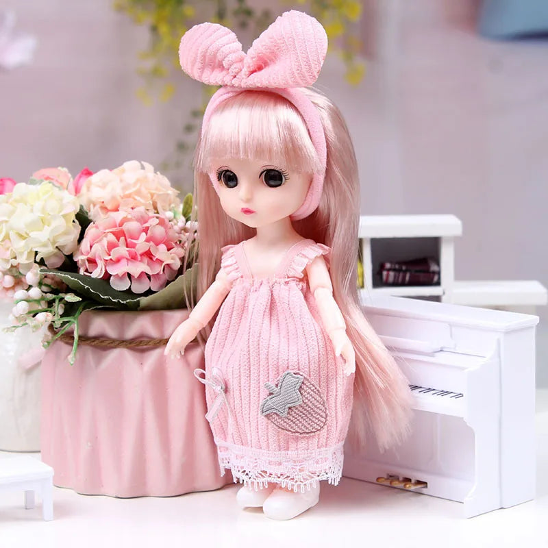 A pink articulated princess doll with long hair wearing a pink dress and a bow accessory.