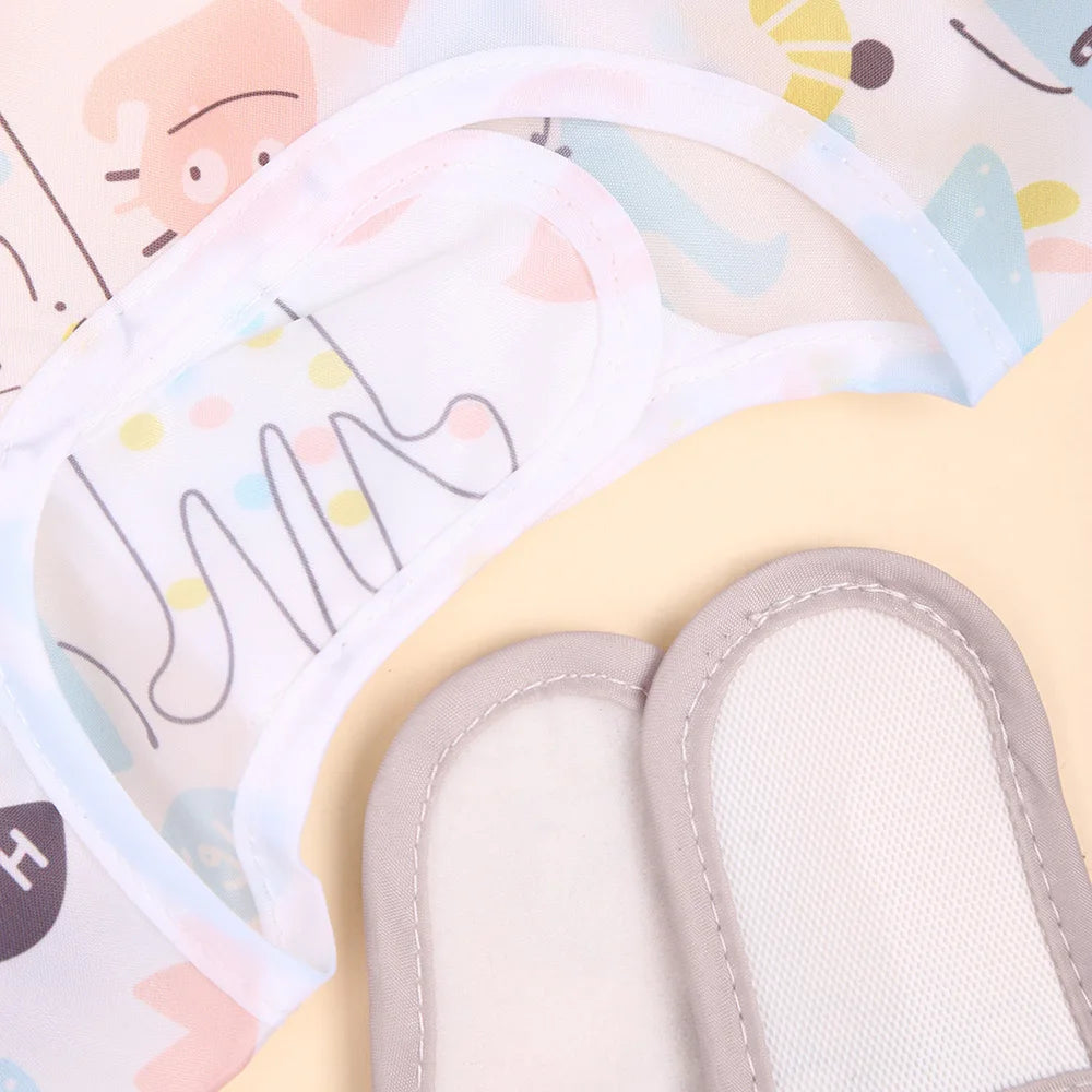 A pair of light blue and pink waterproof full sleeve baby bibs are shown with the inner padding visible.
