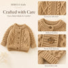 A beige textured cable knit cardigan sweater for kids featuring a ribbed neckline, wood-style buttons, and stretch rib cuffs.