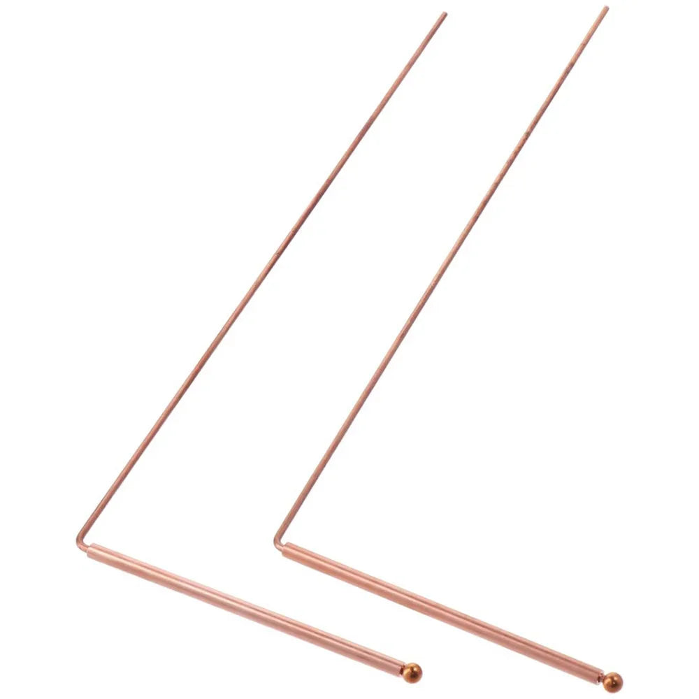 Two thin copper dowsing rods extending diagonally against a white background.