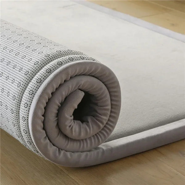 A rolled thick foam baby play mat for crawling and activity, showing the textured surface.